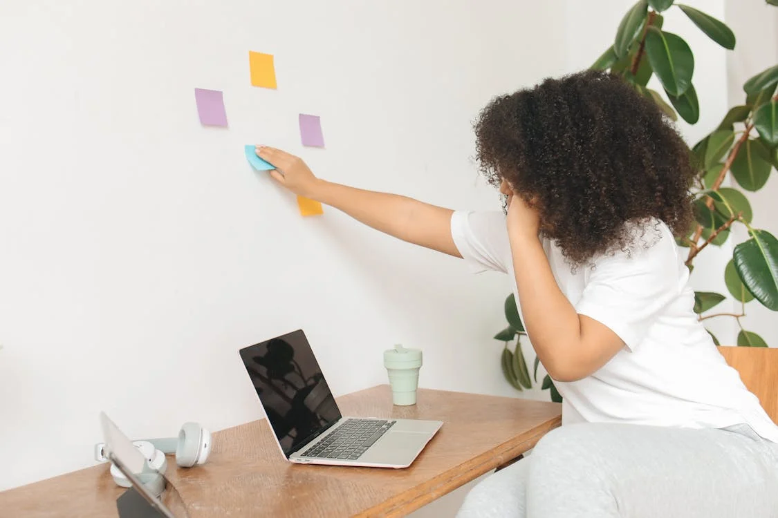 Empreendedor colando post-it na parede mostrando a importância de gerenciar o tempo e usar o estado de flow